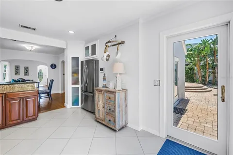 a large white kitchen with stainless steel appliances granite countertop a refrigerator and a stove top oven