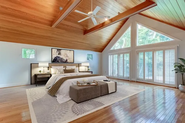 a bedroom with furniture and large windows