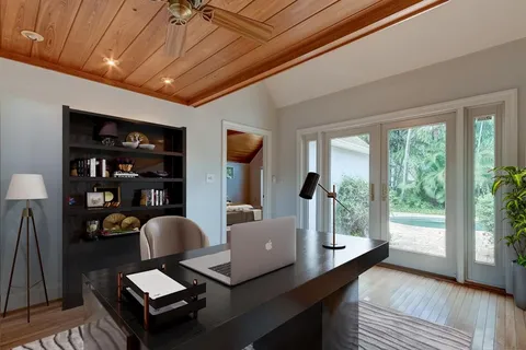 a living room with furniture a flat screen tv and a table