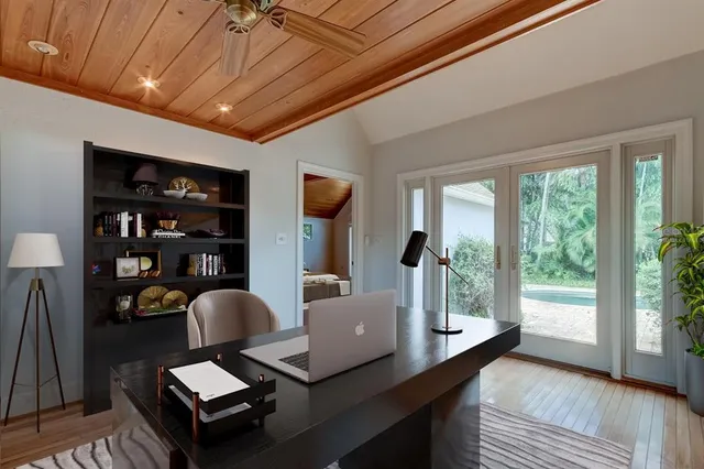 a living room with furniture a flat screen tv and a table