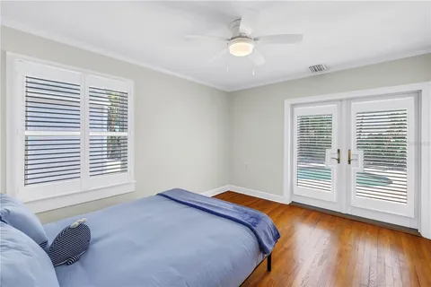 a bedroom with a bed and a large window