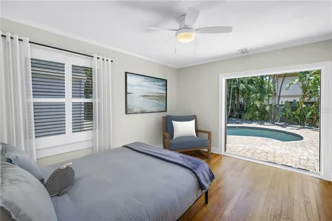 a bedroom with a large bed and a large window with outer view