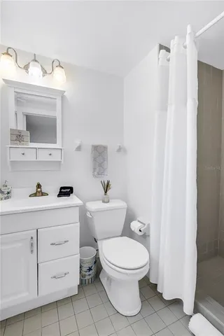 a white toilet sitting next to a bathroom sink