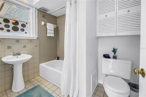 a white toilet sitting next to a bathroom sink