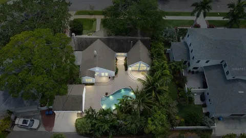 an aerial view of a house with garden space and street view