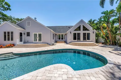 a swimming pool with outdoor seating yard and barbeque oven