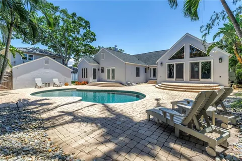 a view of a house with pool and sitting area