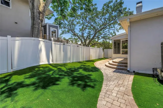 a view of a backyard with a large tree