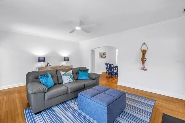 a living room with furniture and a wooden floor