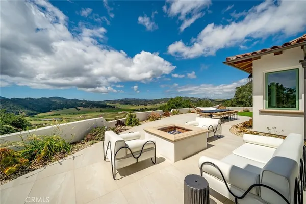 a kitchen with a dining table chairs stainless steel appliances and cabinets