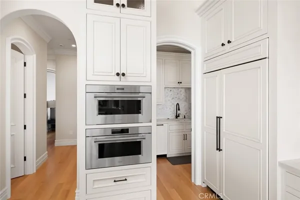 a kitchen with white cabinets and a sink