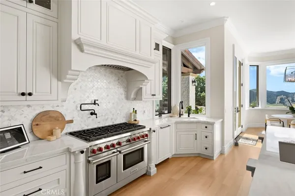 a kitchen with stainless steel appliances a cabinets and wooden floor