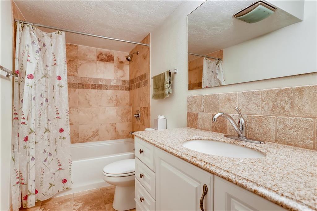 82 Canyon Trail Road Dillon, CO 80435 - Photo 14 of 31 a bathroom with a granite countertop sink toilet and shower