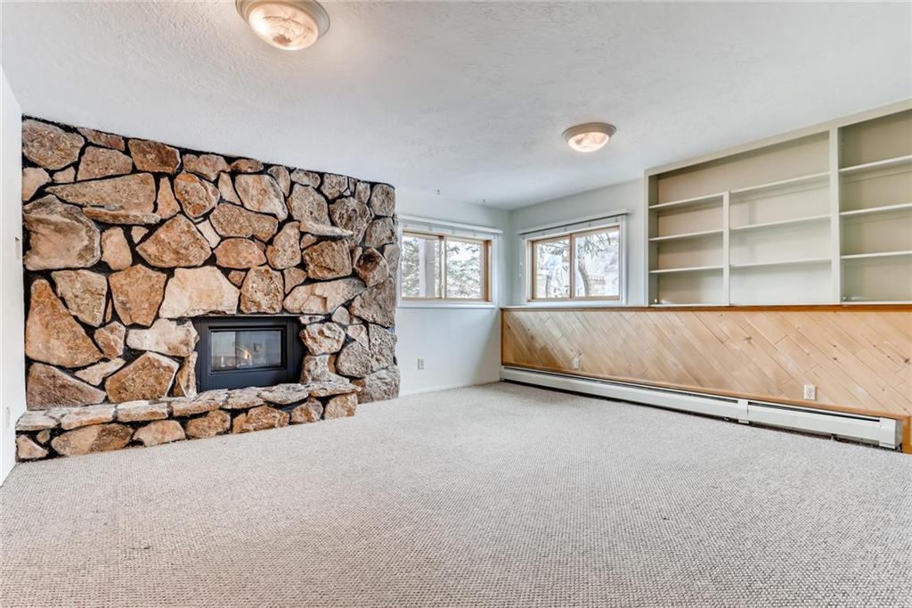 82 Canyon Trail Road Dillon, CO 80435 - Photo 15 of 31 an empty room with a fireplace and painted walls