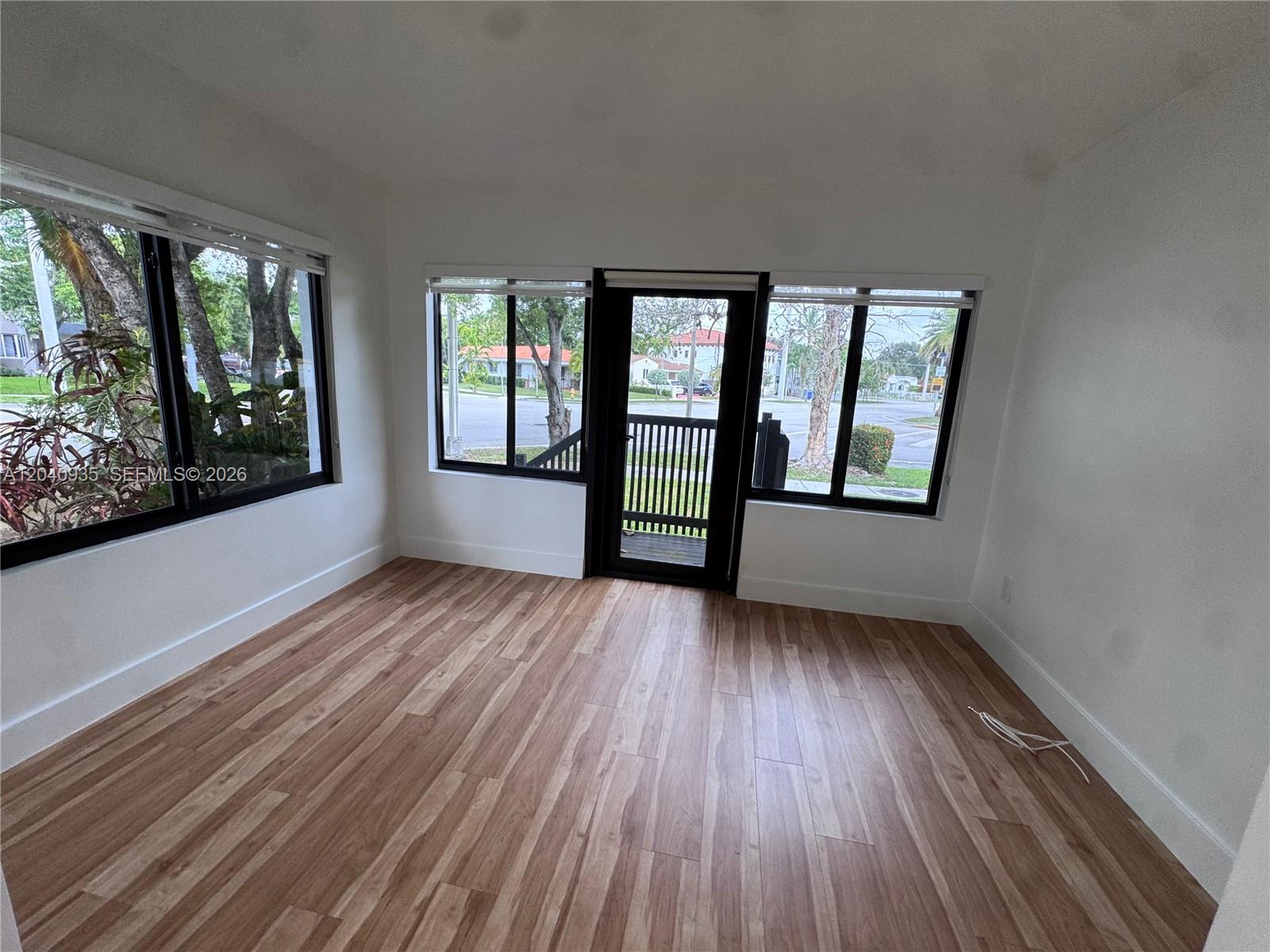 375 Southwest 32nd Road Miami, FL 33129 - Photo 27 of 44 wooden floor in an empty room with a window