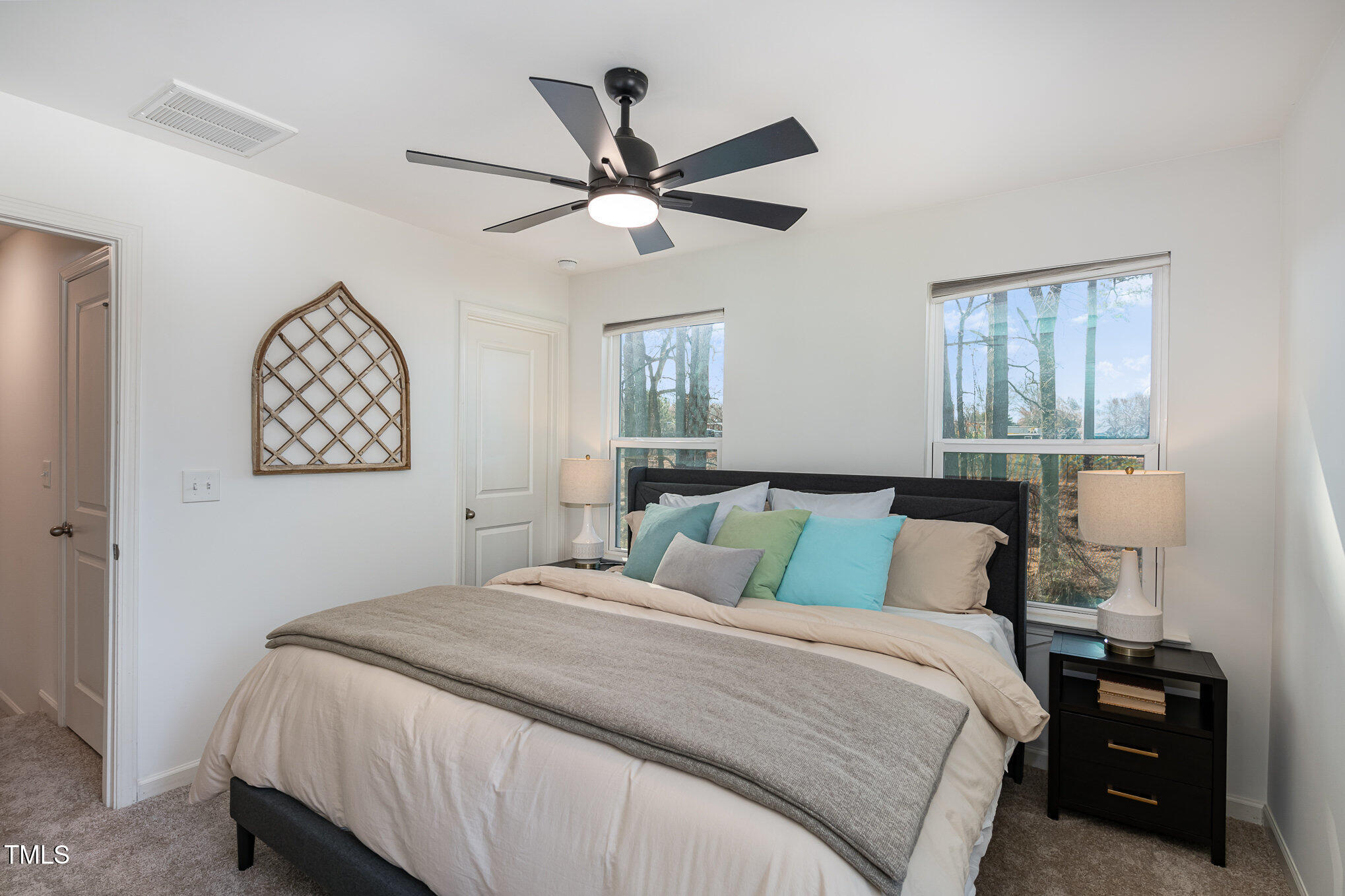 3110 Crater Loop Raleigh, NC 27610 - Photo 20 of 38 a bedroom with a large bed and a chandelier