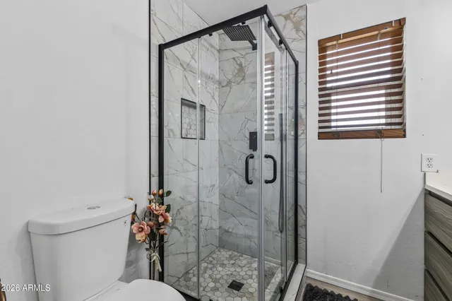 a bathroom with double vanity sinks and a mirror