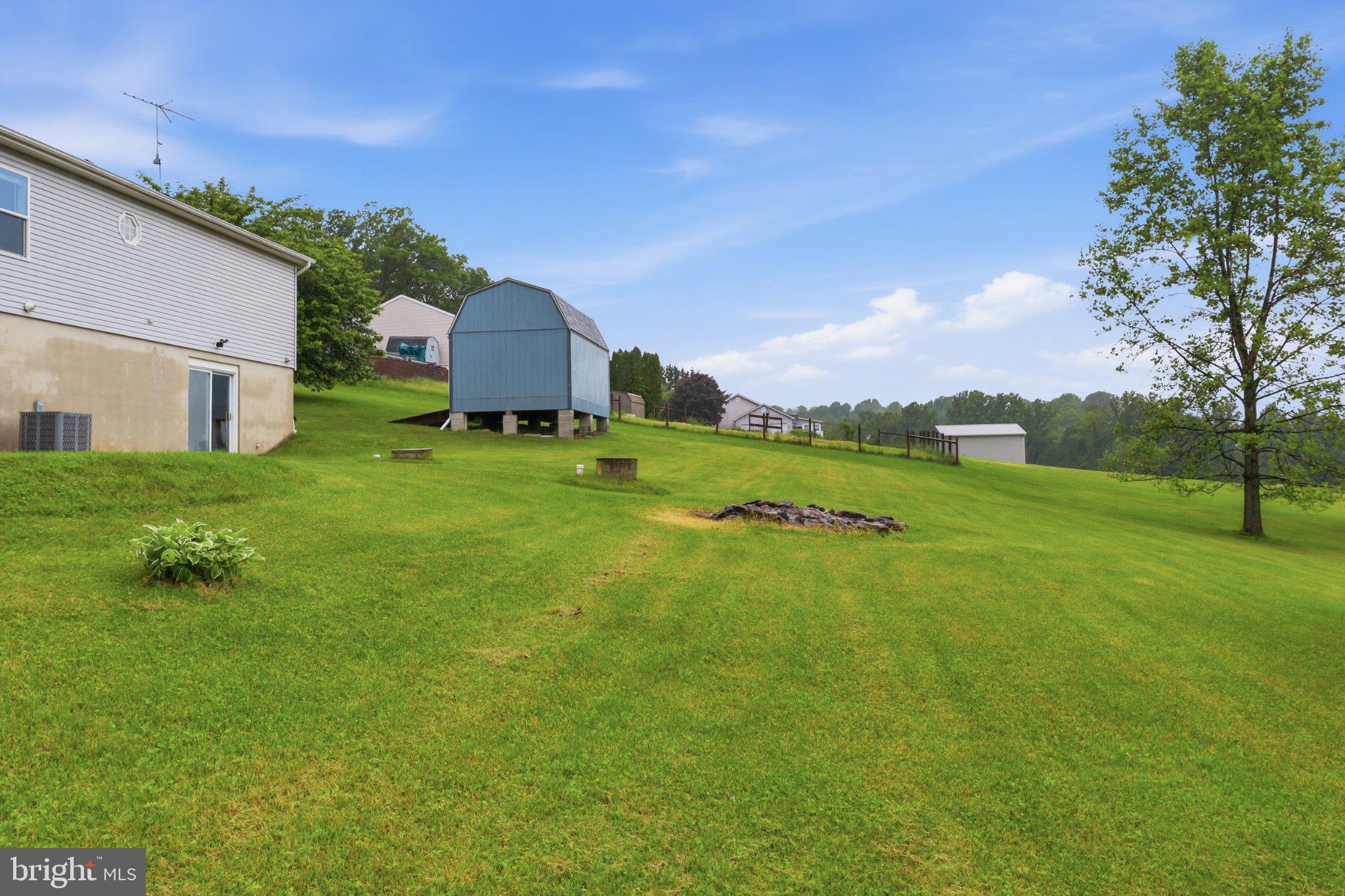 491 Garvine Mill Road Fawn Grove, PA 17321 - Photo 31 of 47 a backyard of a house with a garden and deck