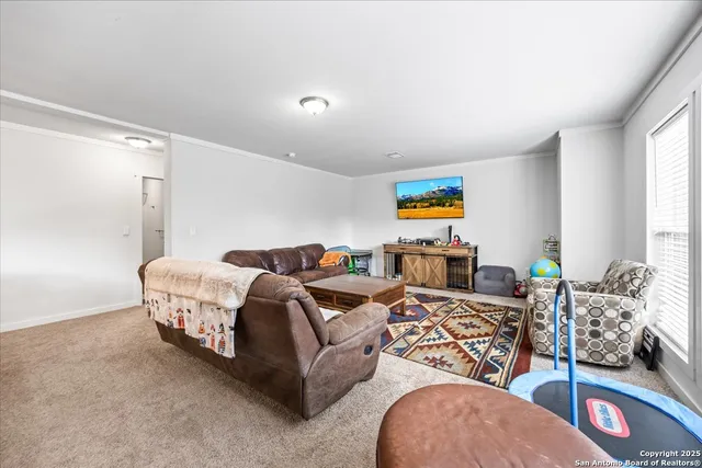 a living room with furniture gym equipment and a window