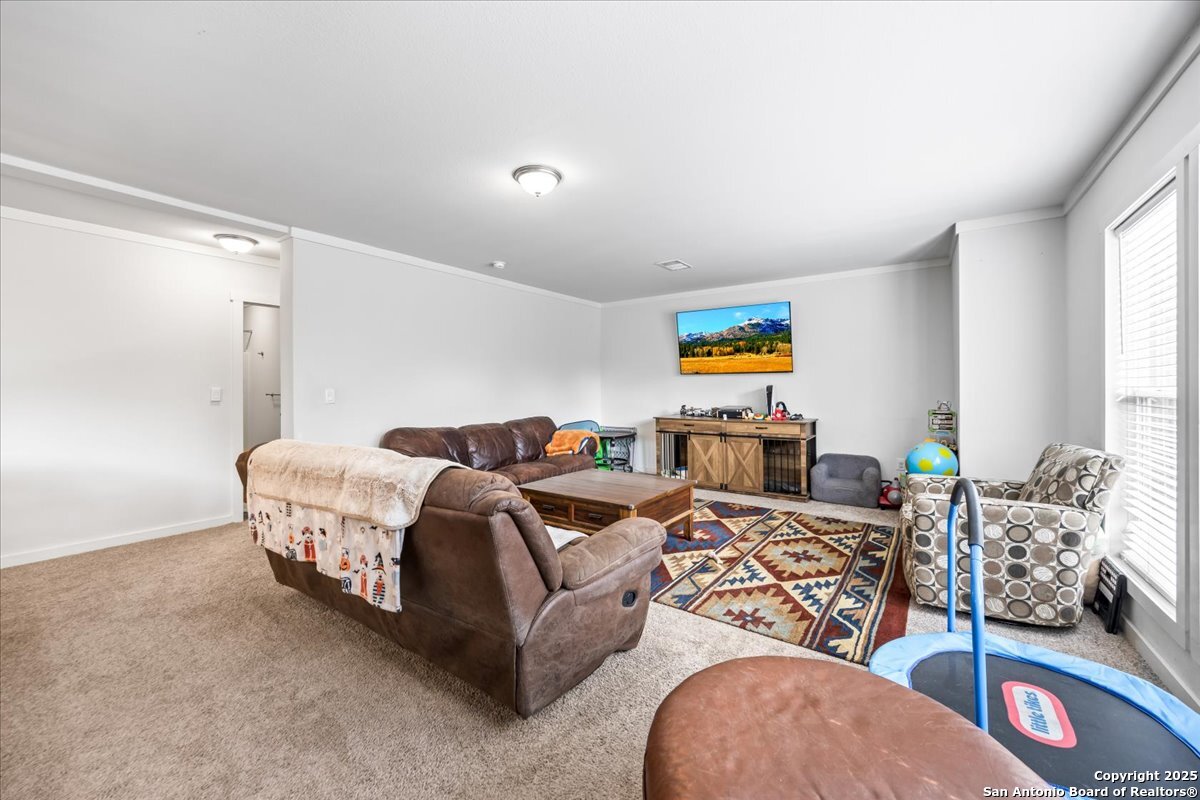 1291 Vivroux Ranch Road Seguin, TX 78155 - Photo 11 of 44 a living room with furniture gym equipment and a window