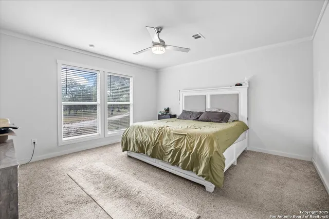 a spacious bedroom with a large bed and a window