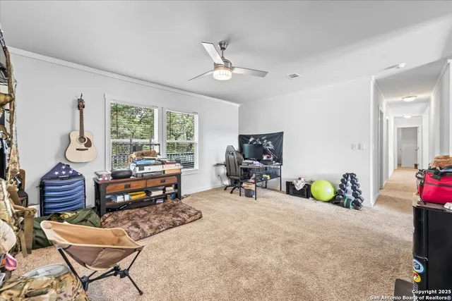 a work room with furniture and a potted plant