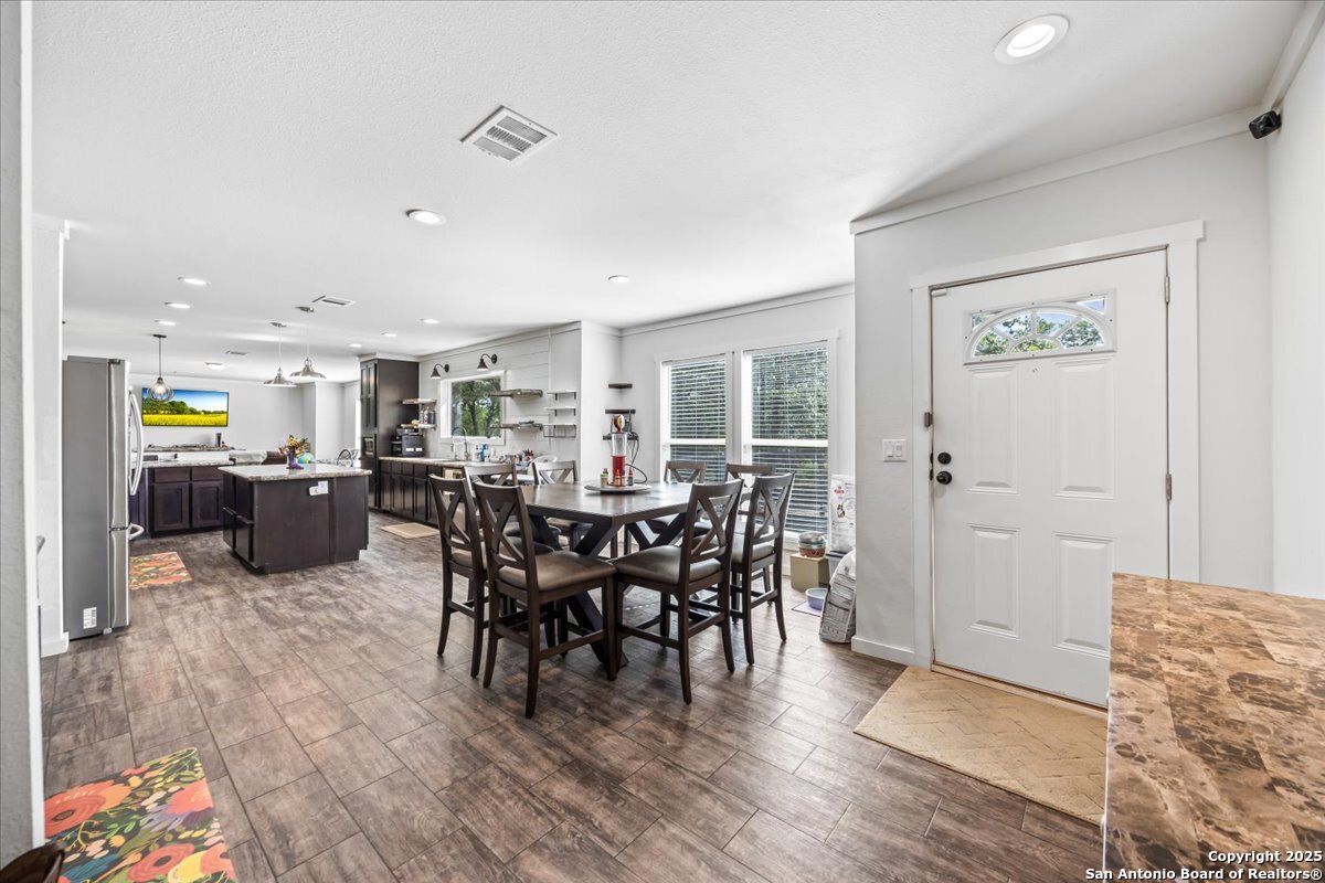 1291 Vivroux Ranch Road Seguin, TX 78155 - Photo 3 of 44 a view of a dining room with furniture window and wooden floor