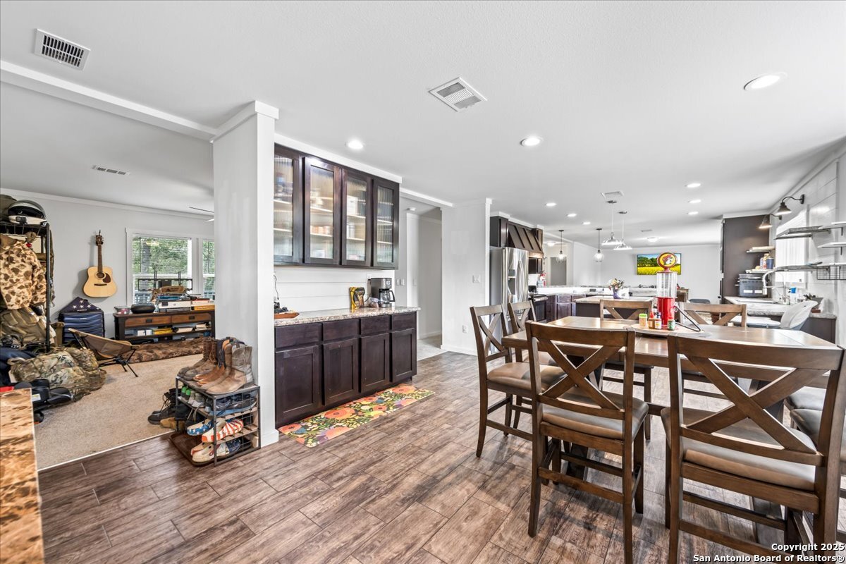 1291 Vivroux Ranch Road Seguin, TX 78155 - Photo 4 of 44 a view of a dining room with furniture a kitchen and chandelier