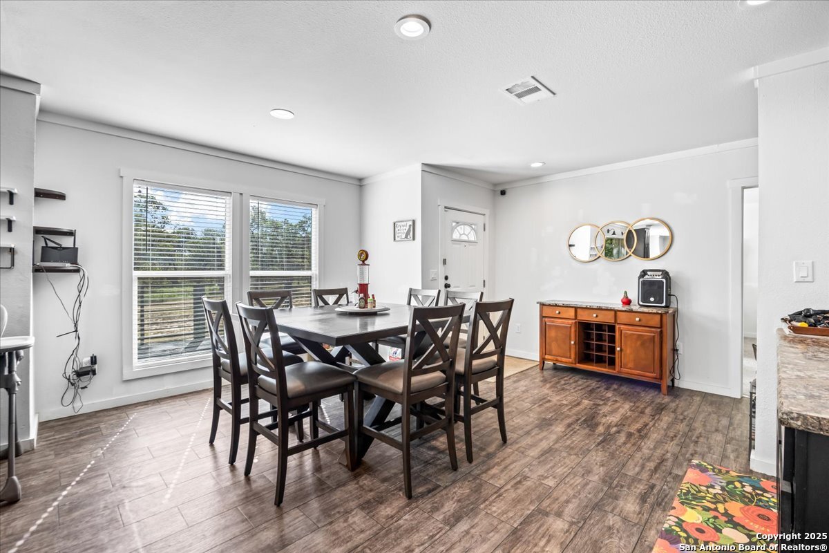1291 Vivroux Ranch Road Seguin, TX 78155 - Photo 5 of 44 a view of a dining room with furniture and wooden floor