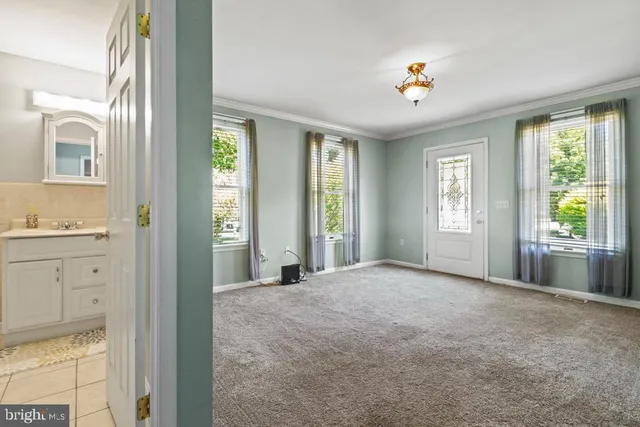 a view of an empty room with window and cabinet