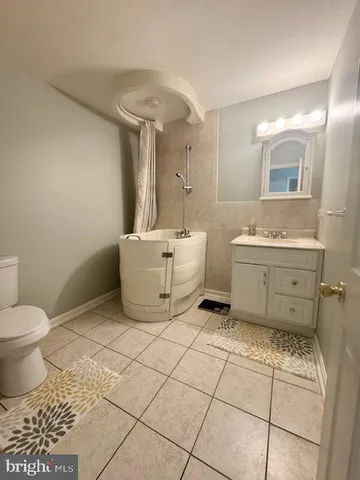 a bathroom with a sink a toilet and mirror