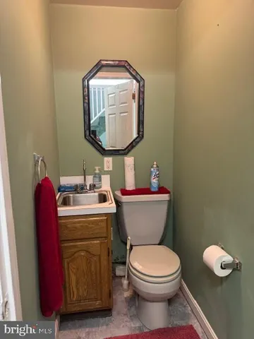 a bathroom with a toilet mirror and vanity