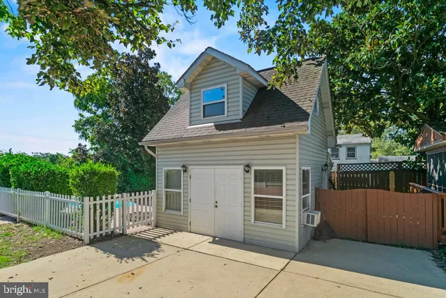 a front view of a house with tree s