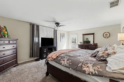 a bedroom with a bed and a television