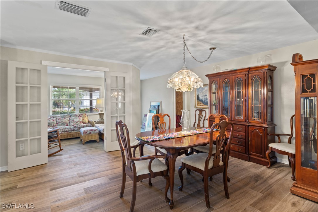 12206 Boat Shell Drive Matlacha Isles, FL 33991 - Photo 11 of 50 a view of a dining room with furniture window and wooden floor