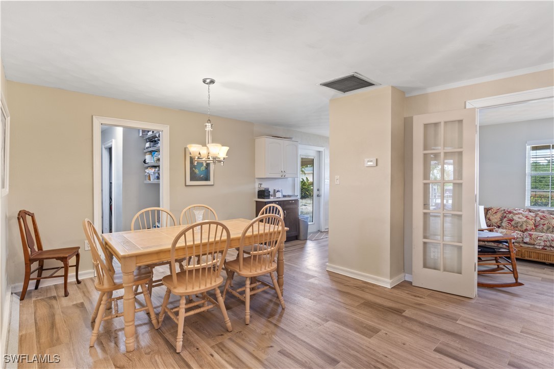 12206 Boat Shell Drive Matlacha Isles, FL 33991 - Photo 13 of 50 a view of a dining room with furniture and wooden floor