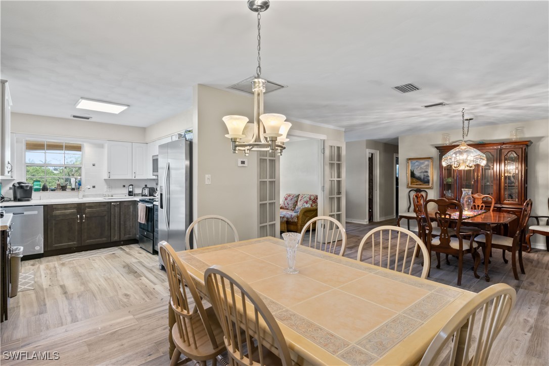 12206 Boat Shell Drive Matlacha Isles, FL 33991 - Photo 15 of 50 a very nice looking dining room with a table chairs and chandelier