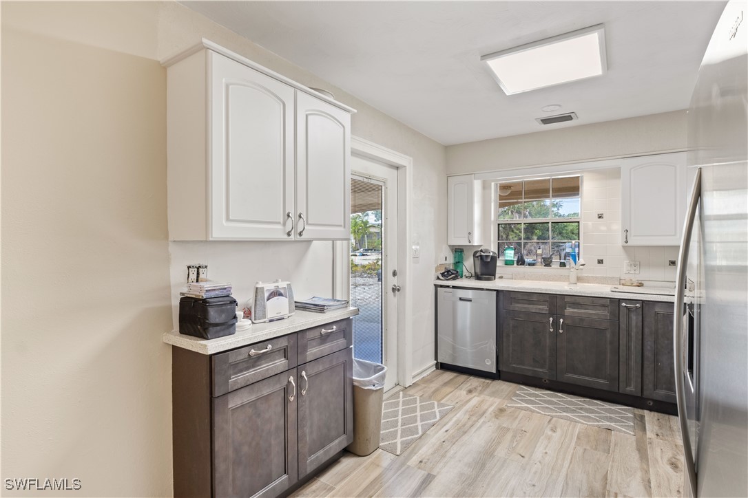 12206 Boat Shell Drive Matlacha Isles, FL 33991 - Photo 17 of 50 a kitchen with a sink stove and cabinets