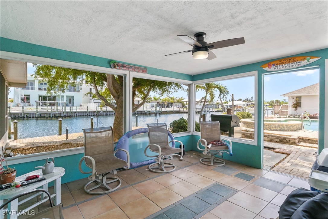 12206 Boat Shell Drive Matlacha Isles, FL 33991 - Photo 28 of 50 a living room with patio furniture and a floor to ceiling window