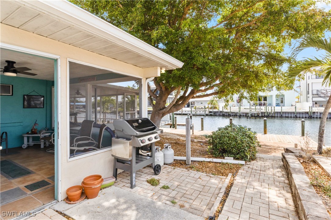 12206 Boat Shell Drive Matlacha Isles, FL 33991 - Photo 29 of 50 a view of a patio with table and chairs and potted plants