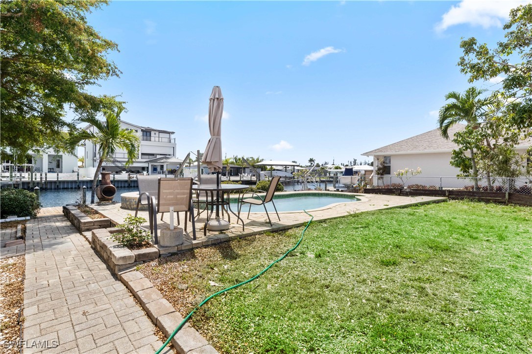 12206 Boat Shell Drive Matlacha Isles, FL 33991 - Photo 30 of 50 a view of a swimming pool with outdoor seating and plants