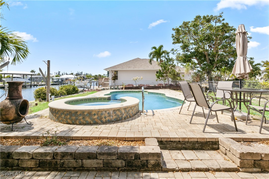 12206 Boat Shell Drive Matlacha Isles, FL 33991 - Photo 31 of 50 a swimming pool with outdoor seating and yard