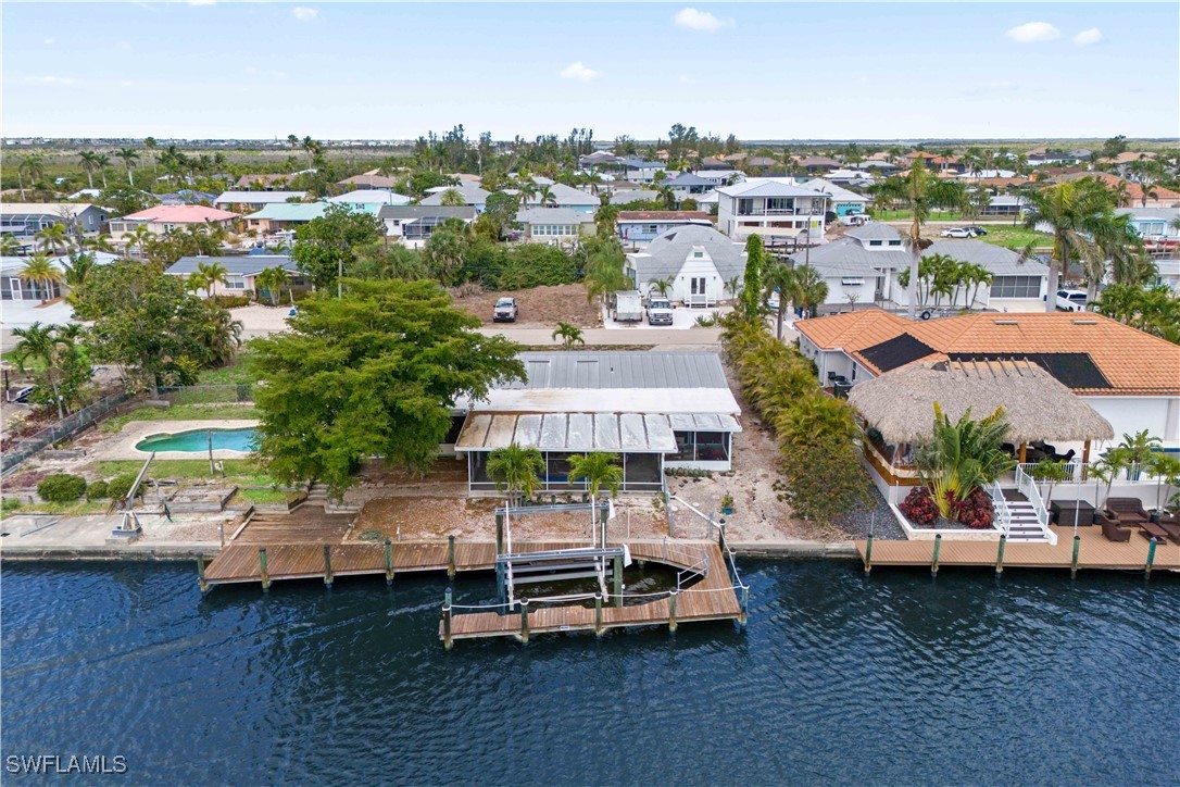 12206 Boat Shell Drive Matlacha Isles, FL 33991 - Photo 40 of 50 an aerial view of a house with a garden and lake view