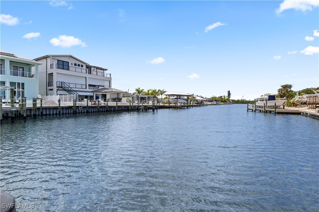 12206 Boat Shell Drive Matlacha Isles, FL 33991 - Photo 45 of 50 a view of a lake with building in front of it