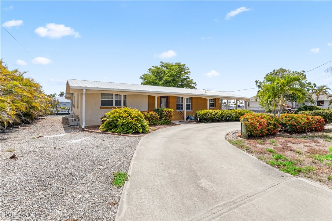 12206 Boat Shell Drive Matlacha Isles, FL 33991 - Photo 7 of 50 a view of a house with a yard and potted plants