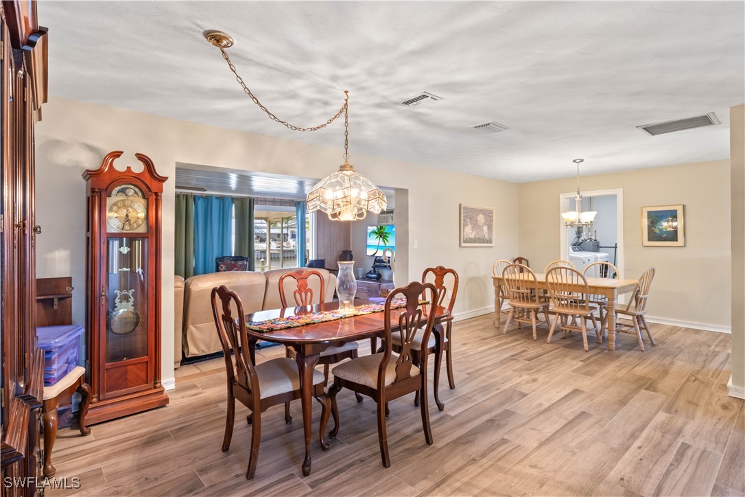 12206 Boat Shell Drive Matlacha Isles, FL 33991 - Photo 9 of 50 a view of a dining room with furniture window and wooden floor