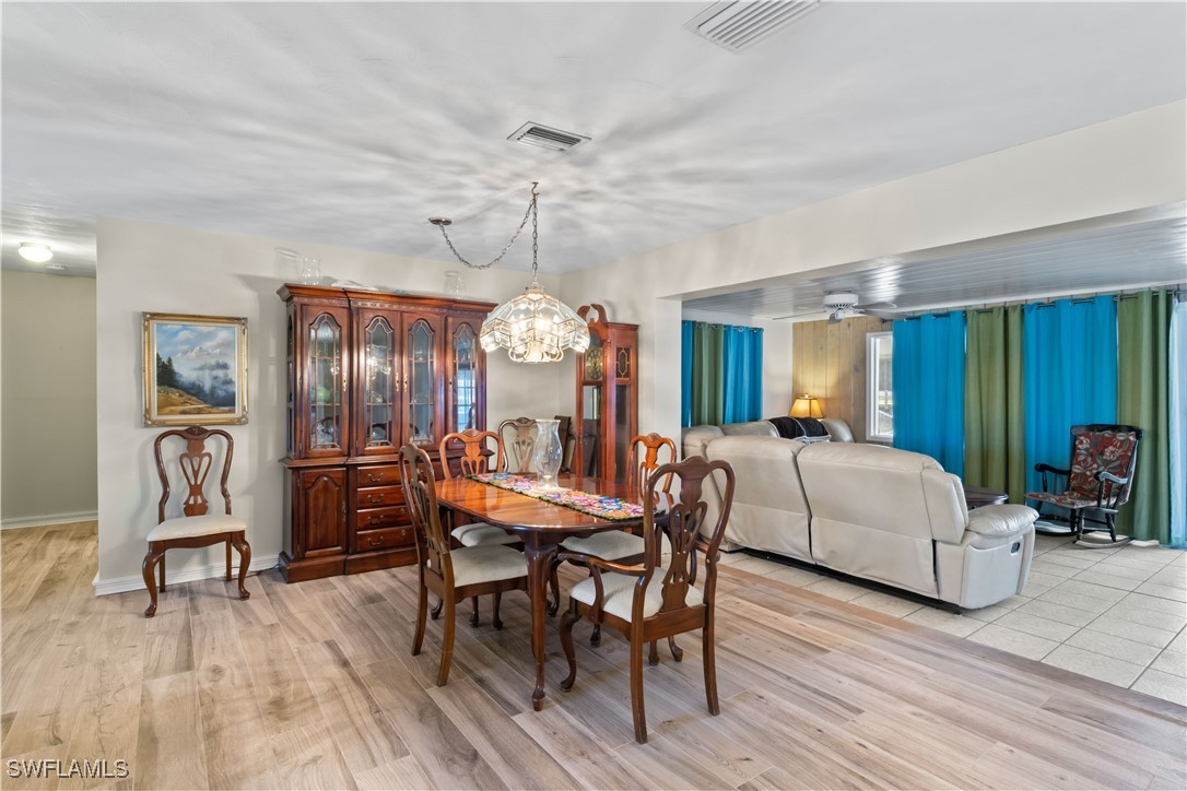 12206 Boat Shell Drive Matlacha Isles, FL 33991 - Photo 10 of 50 a view of a dining room with furniture and chandelier