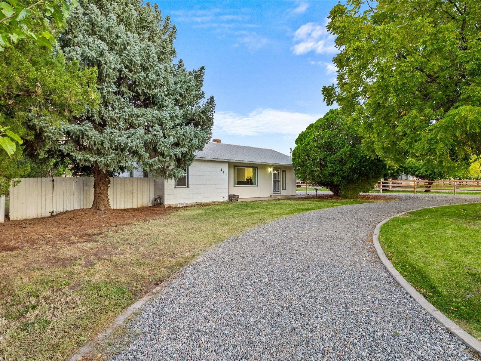 276 29 Road Grand Junction, CO 81503 - Photo 3 of 30 a front view of a house with a yard and garage