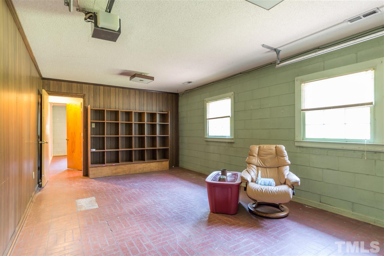709 Merrie Road Raleigh, NC 27606 - Photo 22 of 30 You read that right! This was a much used Den that the family enjoyed and the owner added a garage door for easy access to work on cars and bikes. Heated and cooled with the rest of the home, there are tons of options here.