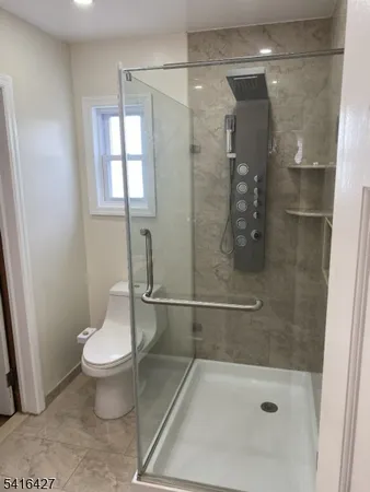 a bathroom with a shower and toilet
